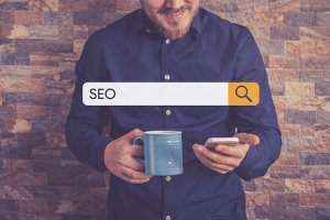 Man searching on Google with SEO in search bar